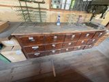 a wooden cabinet with many drawers in a room