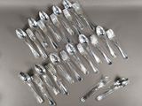 a lot of silver spoons and spoons on a table