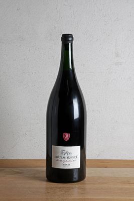 a bottle of wine sitting on a wooden table