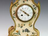 a small clock that is sitting on a table