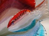 a glass sculpture of a fish that is on a table