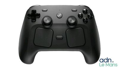 a close up of a black game controller on a white background