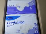 two boxes of sanitary pads sitting on top of a cardboard box