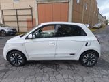 a picture of a small white car parked in a parking lot