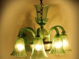 a green glass chandelier hanging from the ceiling