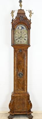 a grandfather clock that is standing in the corner of the room