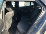 the back seat of a car with the door open in a parking lot