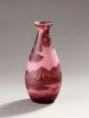 a vase that has a picture of a mountain scene on it