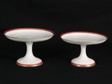 pair of white and red footed bowls with gold rims