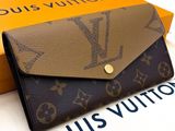 the louis vuitton wallet is sitting on top of a box