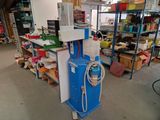 a blue machine that is sitting in the middle of a room