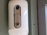 a white toilet paper dispenser hanging on the wall