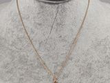 a gold cross necklace on a mannequin mannequin mannequin mannequin mannequin mannequin mannequin mannequin manne