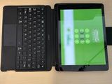 a laptop and a tablet sitting on a desk next to each other