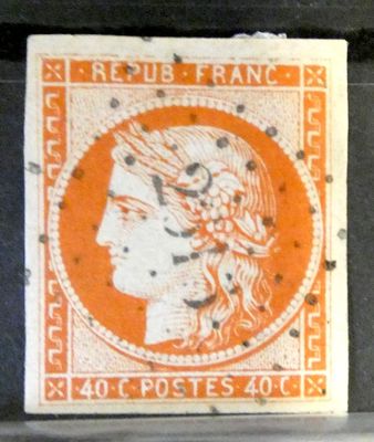 an orange and white stamp with a woman ' s head on it