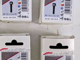 four boxes of assorted staples are sitting on a white surface