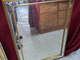 two mirrors sitting on a table with a red table cloth