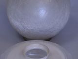 a white object with a green dot on the top of it