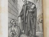 an old book with a picture of a man holding a baby
