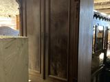 a large wooden cabinet in the middle of a room