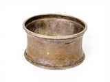 a silver cup that is sitting on a white surface