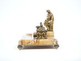 a statue of a man sitting on top of a table