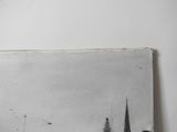 a black and white photo of a cityscape on the wall