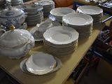 a lot of plates and bowls on the table