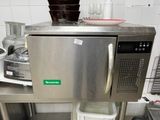 a stainless steel counter top with a machine on it