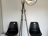 two black chairs and a mirror in a room