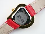 a close up of a wrist watch with a red band