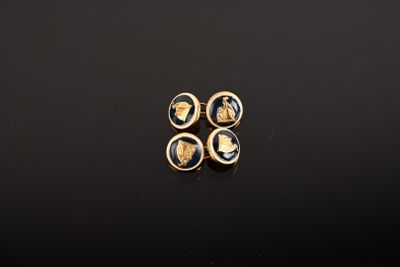 a pair of gold and black earrings with a lady ' s head on them
