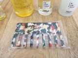 a bottle of liquid, a comb, a bottle of liquid, and a bottle of liquid sitting on a table