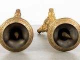pair of antique brass candlesticks on a white background
