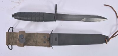 two different types of knives on a white surface