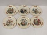 six plates with pictures of people and animals on them on a table