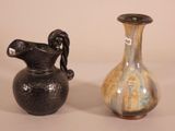 two vases sitting next to each other on a table