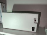a white refrigerator sitting on a white shelf in a room