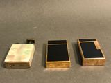 three different types of electronic devices are lined up on a table