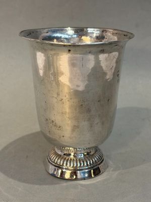 a silver cup that is sitting on a table