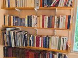 a bookshelf full of books in the corner of the room
