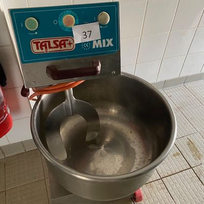 un grand saladier en métal contenant une cuillère en métal