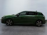 the green car is parked on the concrete floor in the room