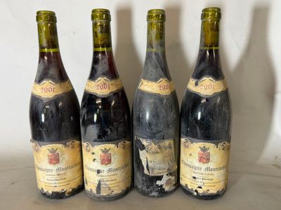 four bottles of wine are lined up on a table