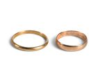 pair of gold wedding rings on a white background