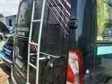 a van that has a ladder on the back of it