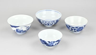 three blue and white bowls and a bowl on a table