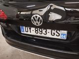 a black car with a luggage bag on the back of it
