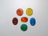 several different colored gummy bears arranged in a circle on a white surface