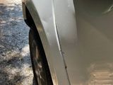 a close up of a car ' s door handle on the side of the road